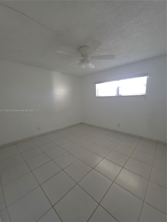 8940 S Hollybrook Blvd Unit 109, Pembroke Pines, FL 33025 - spare room featuring a textured ceiling, ceiling fan, and baseboards