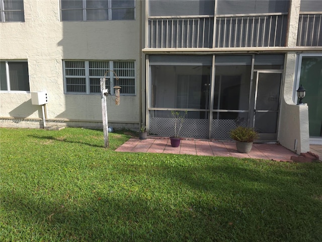 8940 S Hollybrook Blvd Unit 109, Pembroke Pines, FL 33025 - back of property with stucco siding, a yard, and a patio area