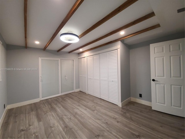 below grade area with recessed lighting, wood finished floors, and baseboards