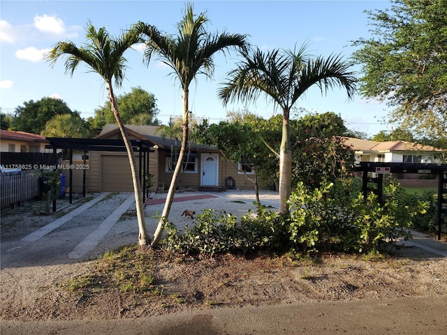 view of front of home with a garage, fence, and driveway