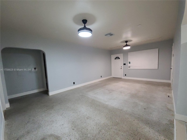 unfurnished room with visible vents and baseboards