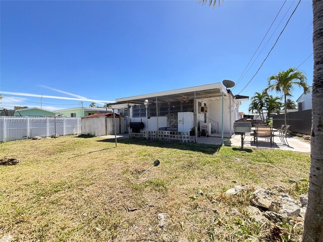 31 W 64th St, Hialeah, FL 33012 - rear view of property with a yard, a patio area, and fence