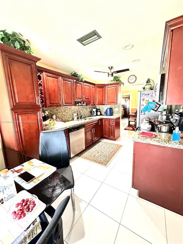 kitchen with visible vents, dark brown cabinets, stainless steel dishwasher, freestanding refrigerator, and tasteful backsplash