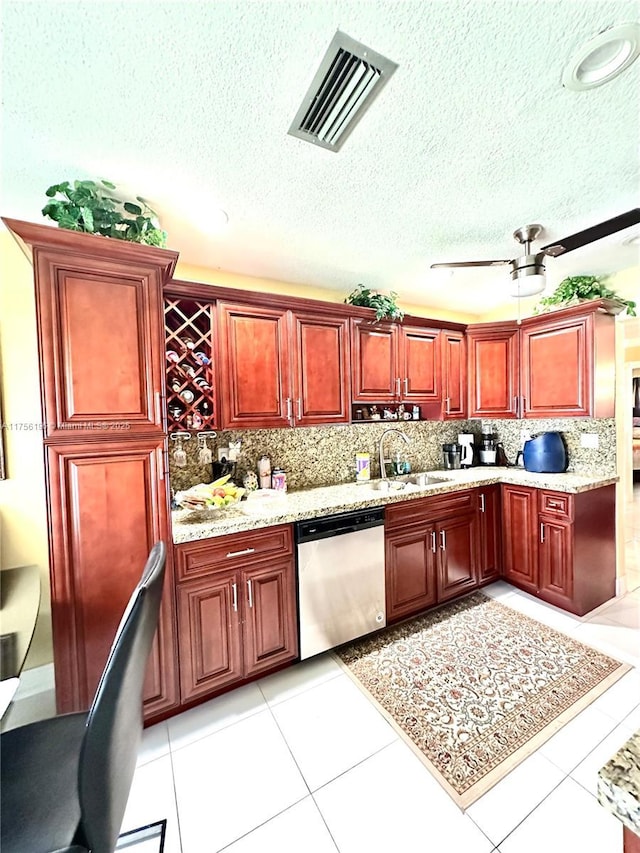 kitchen featuring visible vents, dishwasher, a sink, and dark brown cabinets