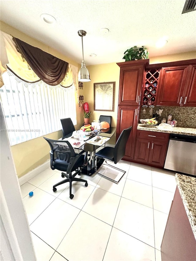 dining space featuring light tile patterned floors, baseboards, visible vents, and a textured ceiling