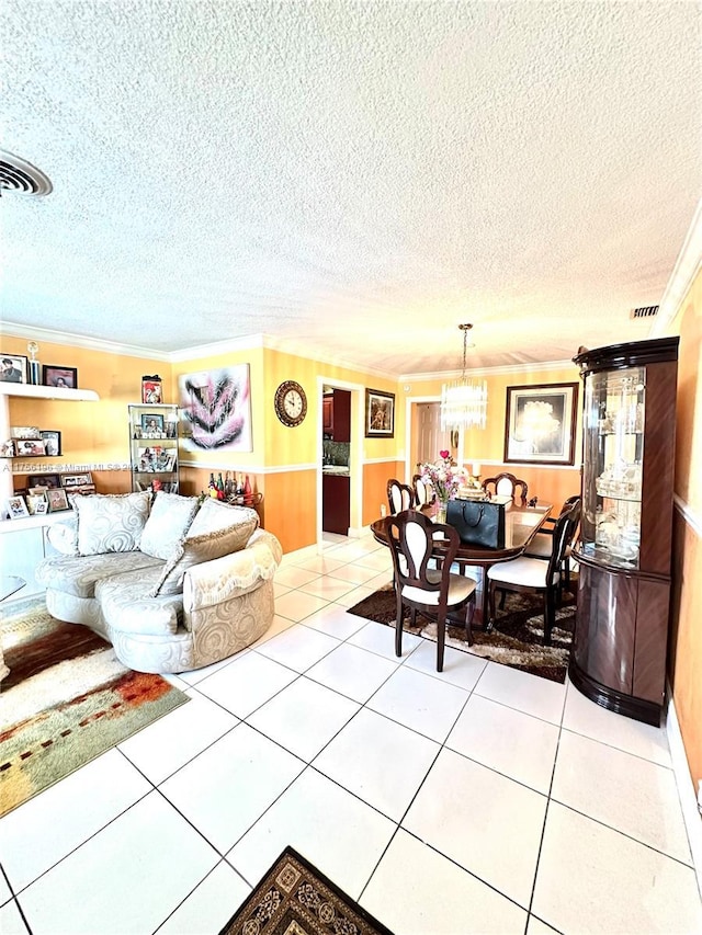 living room with visible vents, a notable chandelier, a textured ceiling, and tile patterned floors