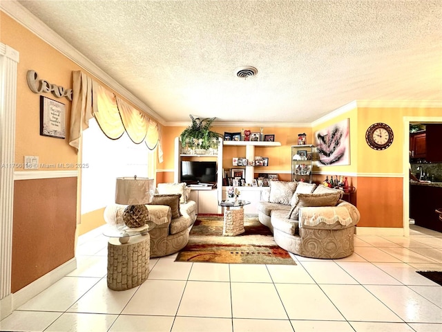 tiled living area with a textured ceiling, visible vents, and crown molding