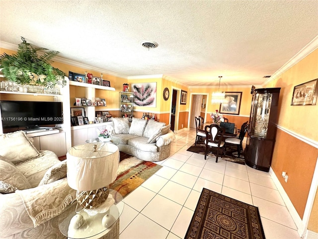 living room with light tile patterned floors, ornamental molding, a textured ceiling, and visible vents