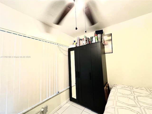 bedroom with ceiling fan and light tile patterned flooring