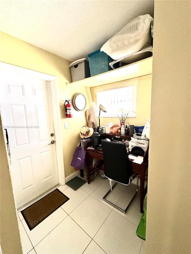 office area featuring a textured ceiling and tile patterned floors