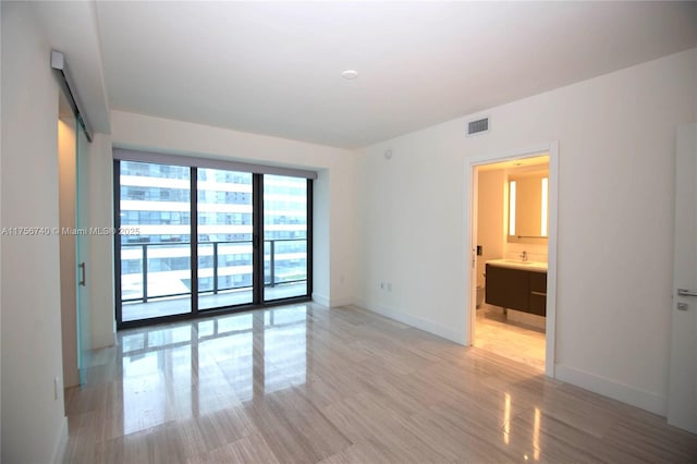 1451 Brickell Ave Unit 1201, Miami, FL 33131 - spare room featuring light wood-style floors and baseboards
