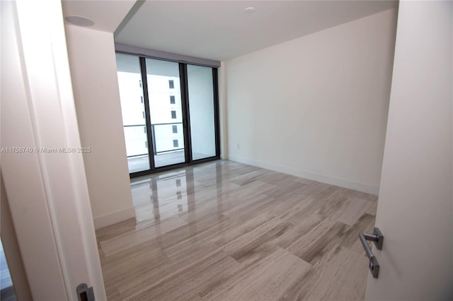 1451 Brickell Ave Unit 1201, Miami, FL 33131 - unfurnished room featuring floor to ceiling windows and light wood-style floors