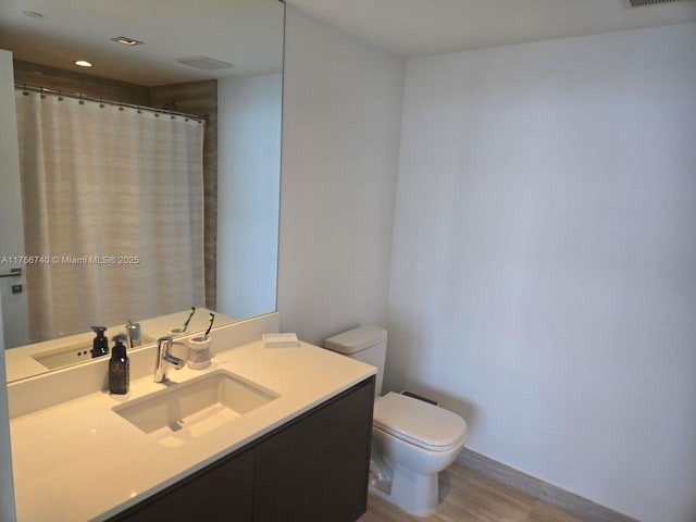 1451 Brickell Ave Unit 1201, Miami, FL 33131 - full bathroom featuring vanity, wood finished floors, and recessed lighting