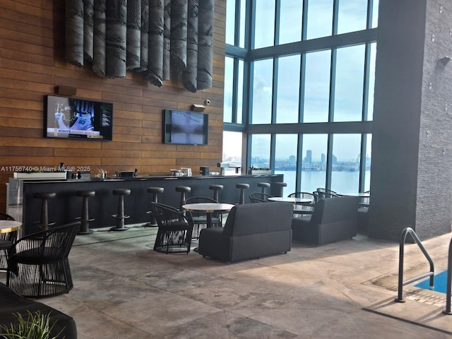 1451 Brickell Ave Unit 1201, Miami, FL 33131 - living area featuring a high ceiling, bar with sink, and wood walls
