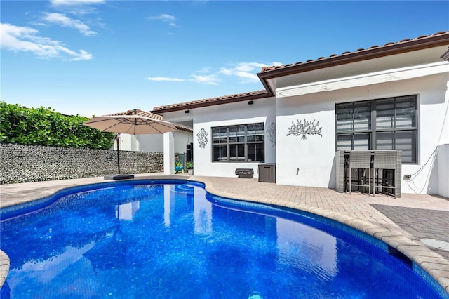 view of swimming pool with fence, a patio area, and a fenced in pool