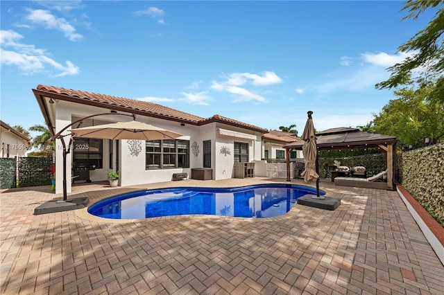 view of pool featuring a gazebo, a fenced backyard, and a patio area