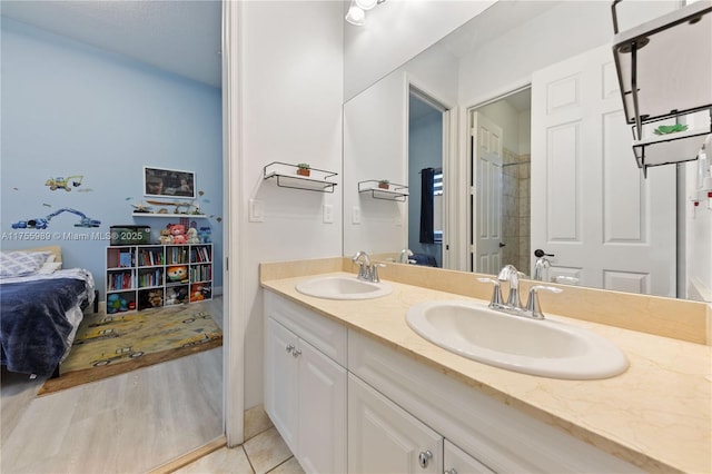 bathroom with double vanity, tile patterned floors, and a sink