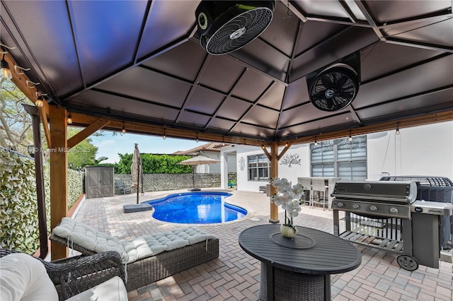 view of pool with fence, a fenced in pool, a gazebo, grilling area, and a patio area