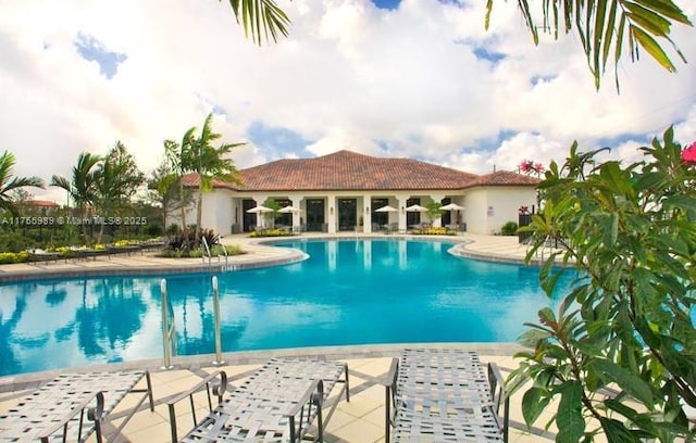 community pool featuring a patio area