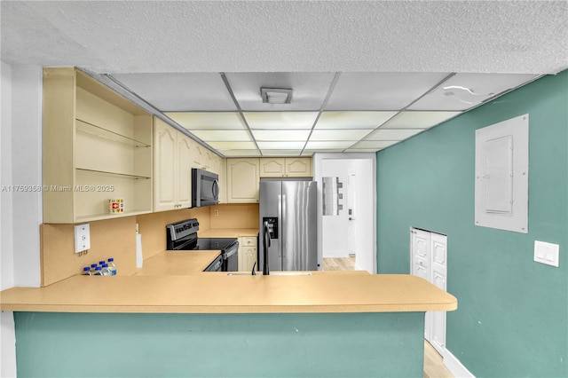 kitchen featuring open shelves, light countertops, appliances with stainless steel finishes, electric panel, and a peninsula