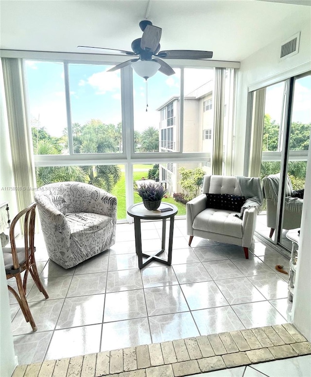 sunroom with visible vents and a ceiling fan