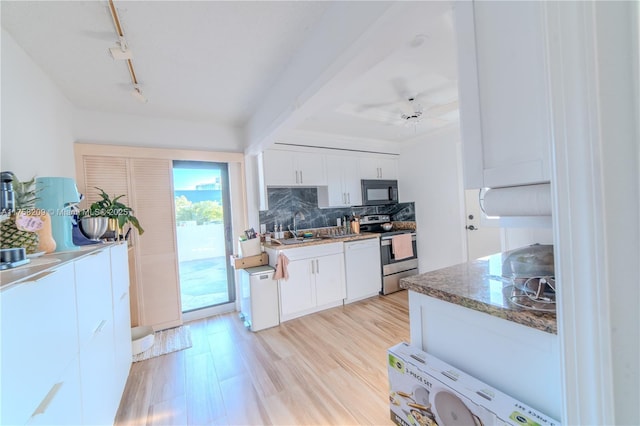 kitchen with tasteful backsplash, white cabinetry, stainless steel range with electric stovetop, black microwave, and dishwasher