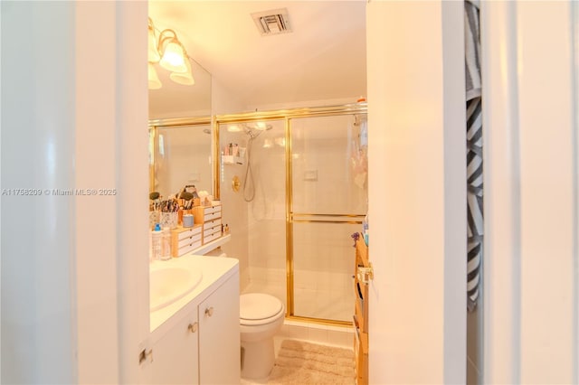 bathroom with a stall shower, visible vents, toilet, tile patterned flooring, and vanity