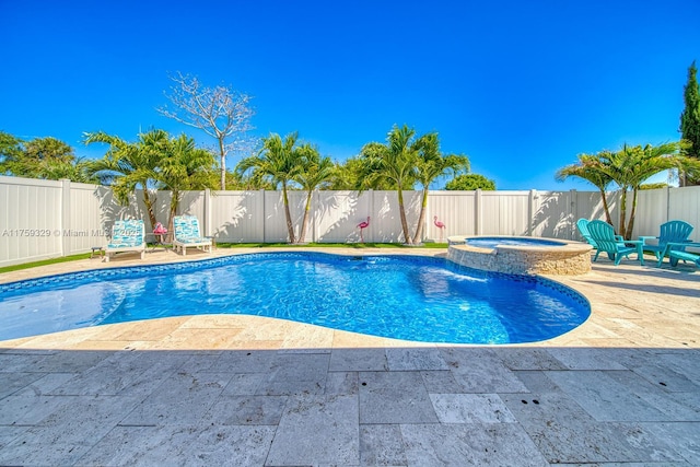 view of swimming pool featuring a pool with connected hot tub, a patio area, and a fenced backyard