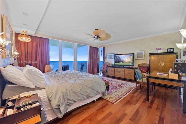 bedroom with ceiling fan with notable chandelier, wood finished floors, and crown molding