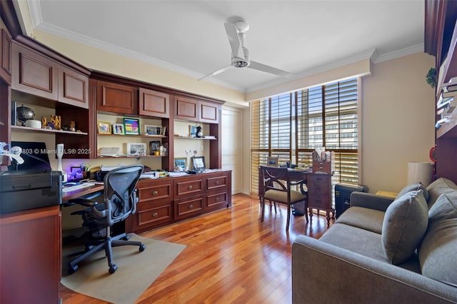 home office with light wood-style flooring, ornamental molding, and ceiling fan