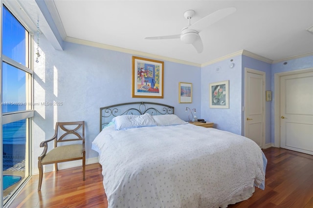 bedroom with ornamental molding, wood finished floors, a ceiling fan, and baseboards