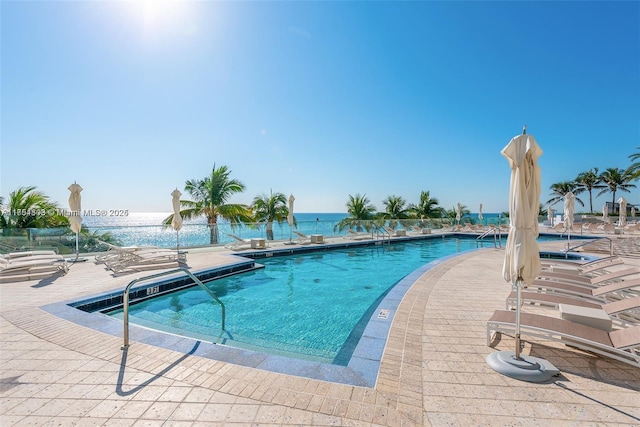 pool with a water view and a patio