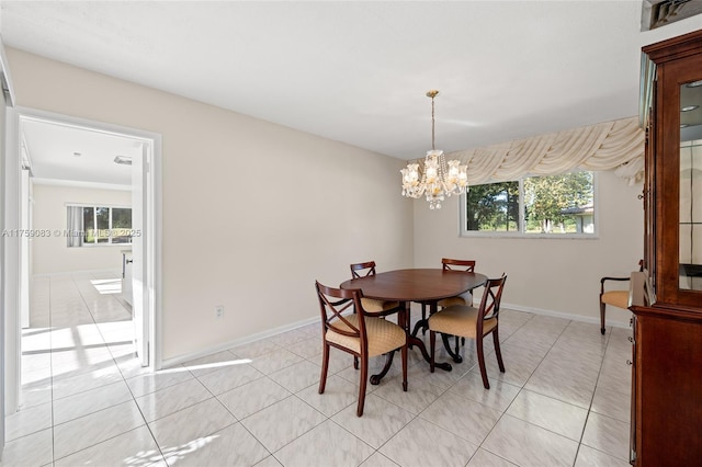dining room featuring a chandelier, healthy amount of natural light, baseboards, and light tile patterned flooring