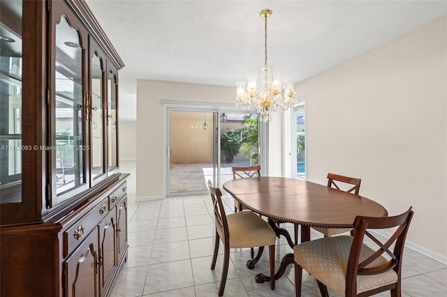 dining space with a notable chandelier, light tile patterned flooring, and baseboards