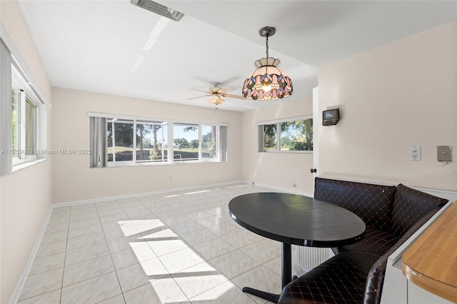 dining room with baseboards, ceiling fan, and light tile patterned floors