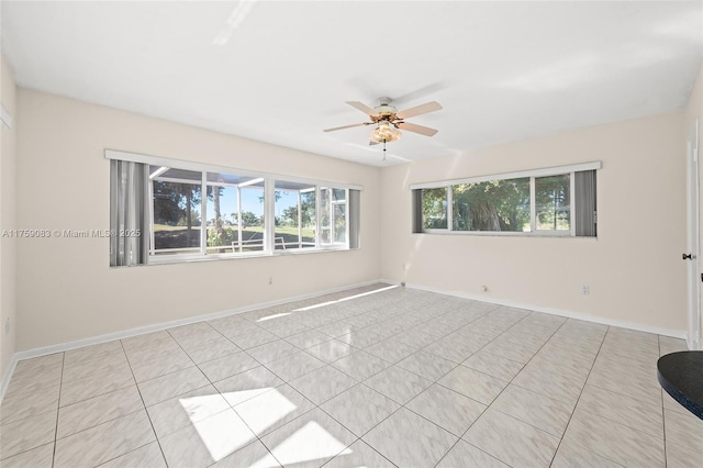 unfurnished room featuring ceiling fan, tile patterned floors, and baseboards