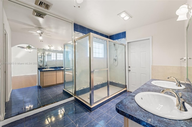 full bathroom featuring double vanity, tile patterned flooring, a stall shower, and a ceiling fan
