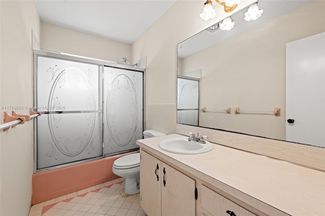 full bathroom featuring toilet, tile patterned flooring, enclosed tub / shower combo, and vanity