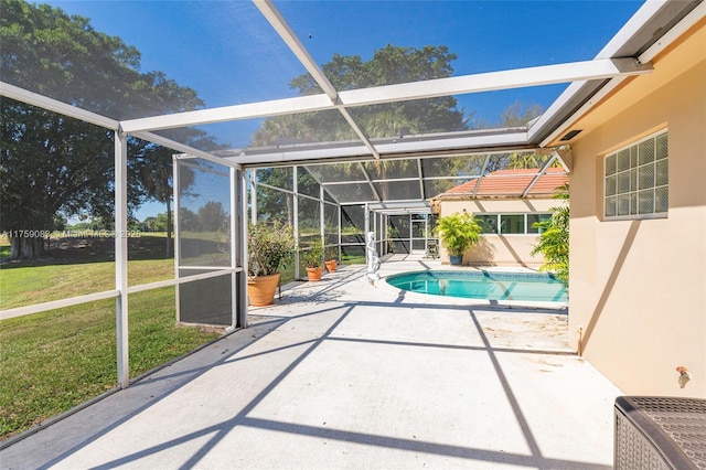 pool with glass enclosure, a patio area, and a yard