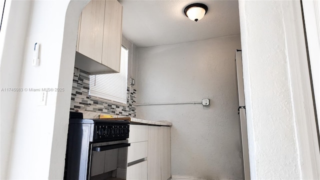 kitchen with tasteful backsplash and a textured wall