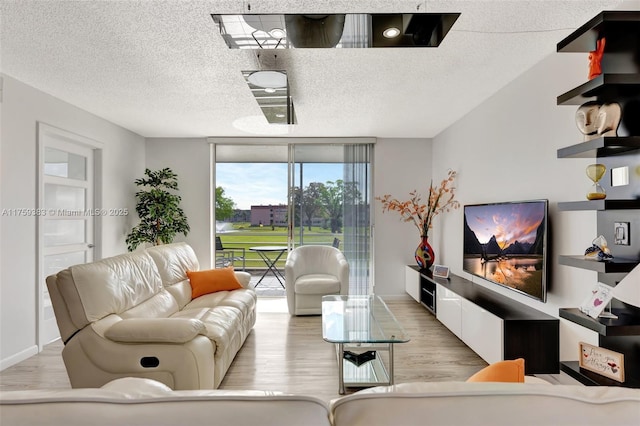 living area featuring a wall of windows, a textured ceiling, and wood finished floors