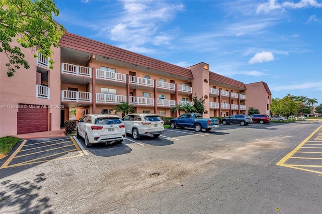 view of building exterior with uncovered parking