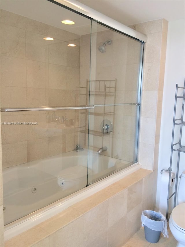 full bathroom featuring toilet, tile patterned floors, and tiled shower / bath combo