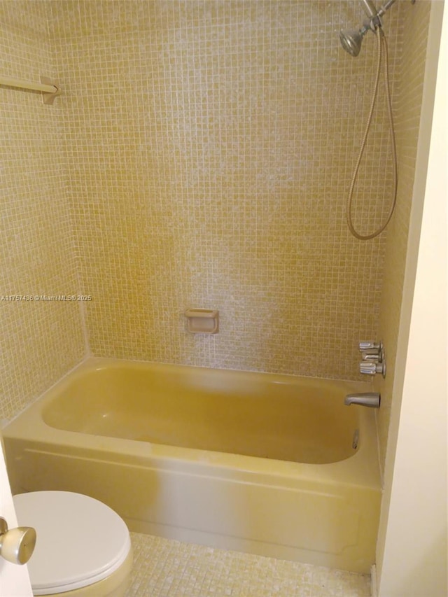 bathroom with shower / bathtub combination, toilet, and tile patterned floors