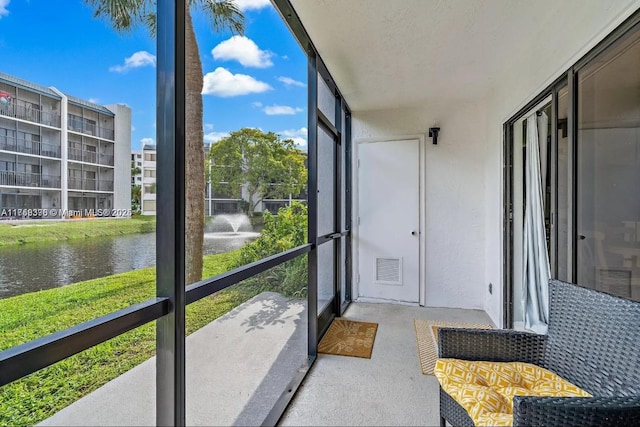 sunroom with a water view and visible vents