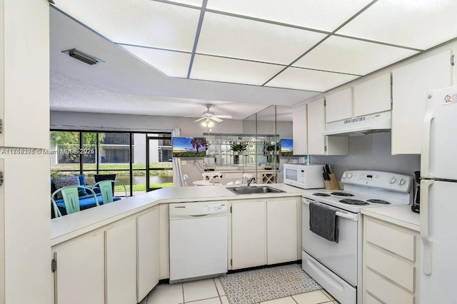 kitchen featuring ceiling fan, under cabinet range hood, white appliances, a sink, and light countertops