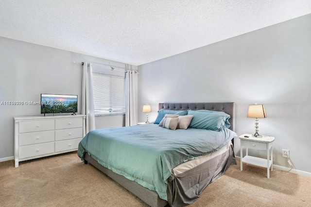 bedroom featuring a textured ceiling, carpet flooring, and baseboards