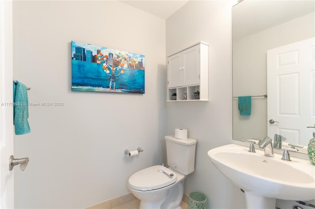 bathroom featuring a sink and toilet