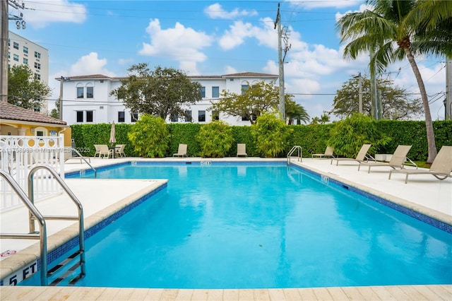 pool featuring a patio area and fence