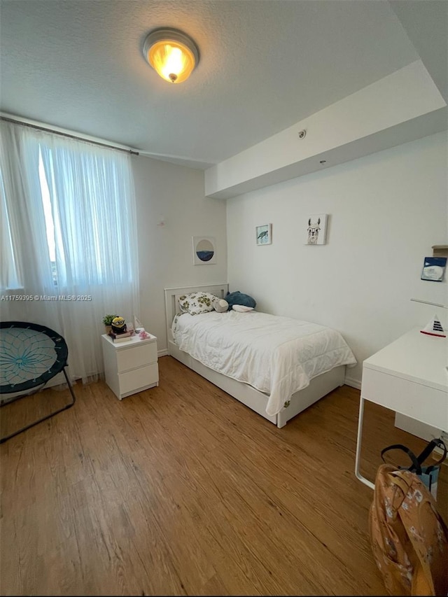 bedroom with wood finished floors